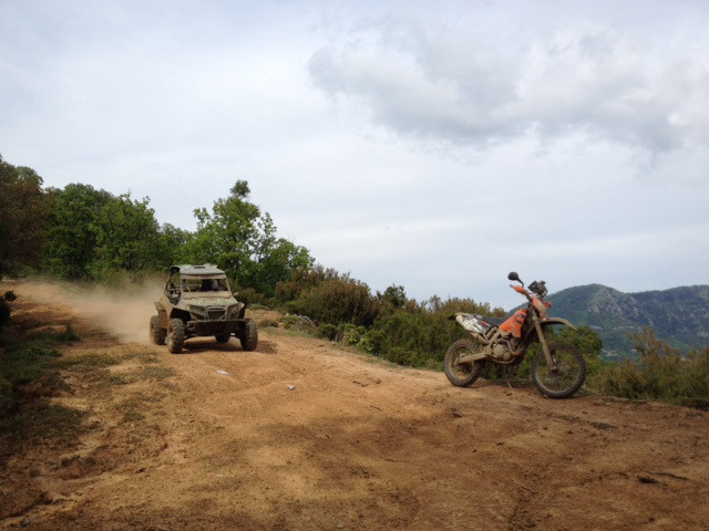 bike and car on dirt track